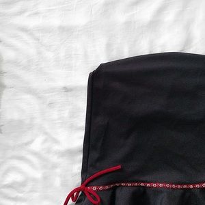 black ruffle hem skirt with red floral ribboning